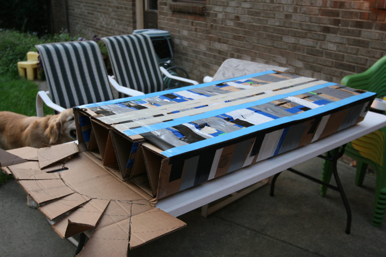 Building Surfboat V2...adding outer layer of cardboard to cardboard trusses... Marsha Tufft